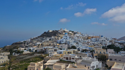 Aerial drone photo of iconic small traditional village and uphill castle of Pyrgos with great views to Santorini island Cladera, Cyclades, Greece