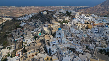 Aerial drone photo of iconic small traditional village and uphill castle of Pyrgos with great views to Santorini island Cladera, Cyclades, Greece