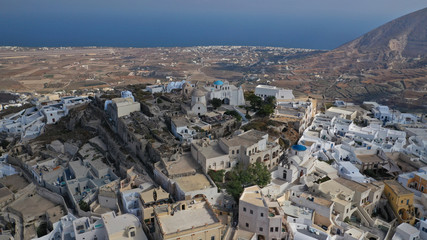 Aerial drone photo of iconic small traditional village and uphill castle of Pyrgos with great views to Santorini island Cladera, Cyclades, Greece