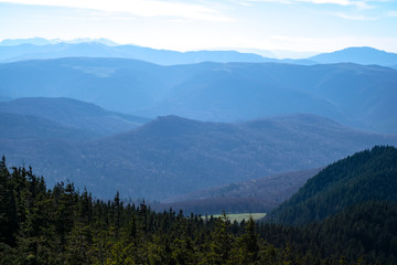 Fototapeta premium Mountains peak through fog