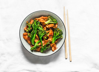 Teriyaki stir fry chicken with broccoli and noodles on light background, top view. Asian style food