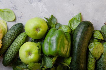 Healthy vegetarian food concept background, fresh green food selection for detox diet, raw cauliflower, apple, cucumber, feijoa, spinach, paprica, basil, view from above, flat lay, banner