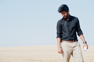 South asian agronomist farmer inspecting wheat field farm. Agriculture production concept.