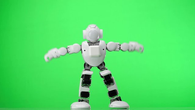 Humanoid robot dances a popular style dance. Green screen.