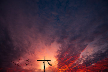 Cross and a dramatic epic sunrise