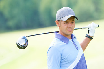 golfer in golf field with club