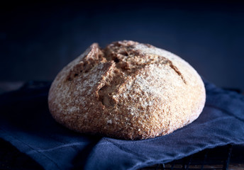 Homemade  whole wheat rustic bread on wooden table. 