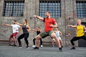 Fototapeta premium Group of people training fitness and martial arts together
