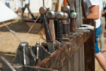 Detail of medieval blacksmith's clothing, tools and weapons in the traditional yearly Medieval Market celebration in monastery of Manasija in Serbia