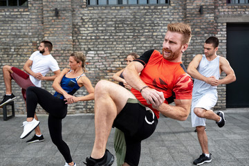 Athletes performing a knee kick
