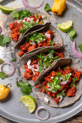 Mexican chorizo tacos with blue corn tortillas on rustic background