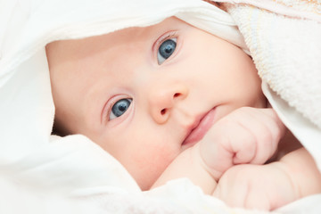 newborn little baby in white clothing
