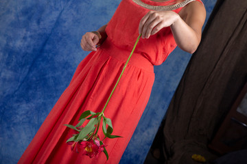 Red flowers in beautiful female hands