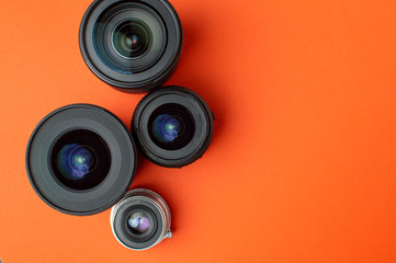 Progress of different photo lenses on a colored background, a set of old and modern photo devices...