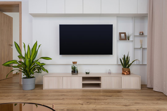Interior of contemporary living room with TV on the wall