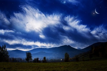 Obraz premium Moon and mountains . Beautiful night . A young month. Cloud landscape . Generous Ramadan . Light from sky . Religion background .