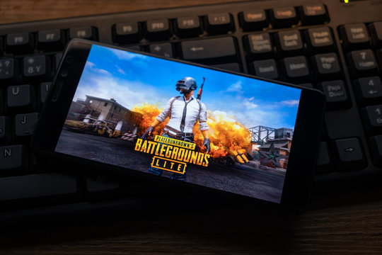 Kostanay, Kazakhstan, October 19, 2019.Mobile phone on the background of the keyboard, with the logo of the popular game Playerunknown's Battlegrounds abbreviated PUBG.