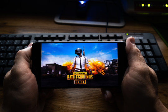 Kostanay, Kazakhstan, October 19, 2019.Mobile phone on the background of the keyboard, with the logo of the popular game Playerunknown's Battlegrounds abbreviated PUBG.
