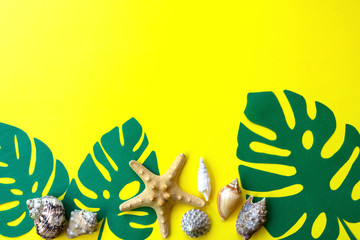 Naklejka premium Creative layout made of monstera leaves and seashells with copy space