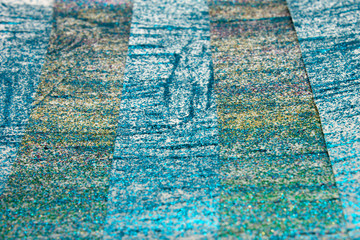 Fototapeta na wymiar This is a photograph of an abstract background created by organizing stripes created using Blue,turquoise,green,pink and gold glitter paint