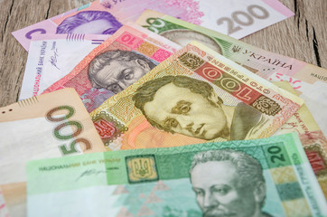 Ukrainian money on a wooden background.
