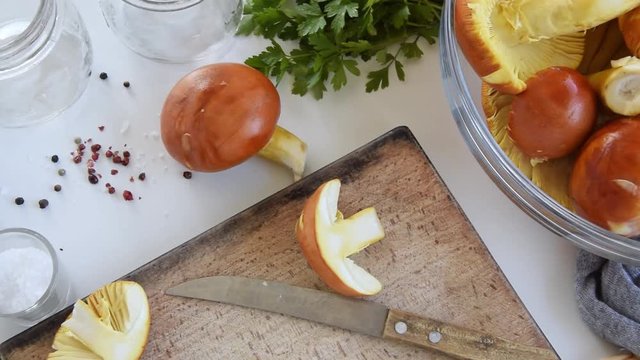 Personal perspective of woman hands cooking Amanita caesarea (known as Caesar's mushroom)