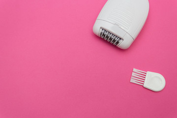 Fototapeta na wymiar White electric epilator for hair on pink background. Beauty concept. Copy space