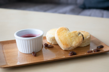 Round and Heart Scones on top with Dries Raisins with Raspberry Jam 
