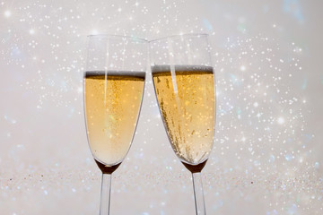New Years eve concept with bokeh, fireworks and glasses of champagne. 