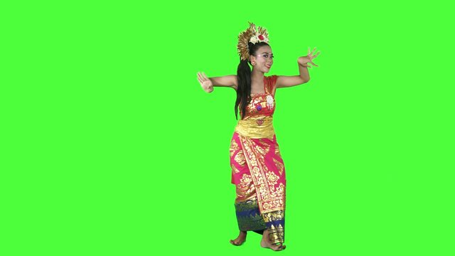 Beautiful balinese dancer dancing in the studio while wearing traditional clothes. Shot in 4k resolution