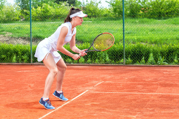 Fototapeta na wymiar Pretty girl playing tennis outdoors