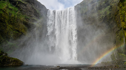 Huge waterfall of Skogafoss with a rainbow formed from sun shine, Skogar, south of Iceland
