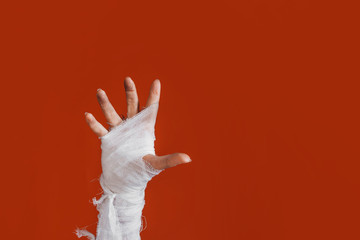Halloween, costume image. The mummy's hand in bandages making gestures