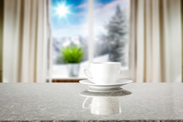 Winter decorations in bright colors with blurred snowy white and silver winter outside the window background.