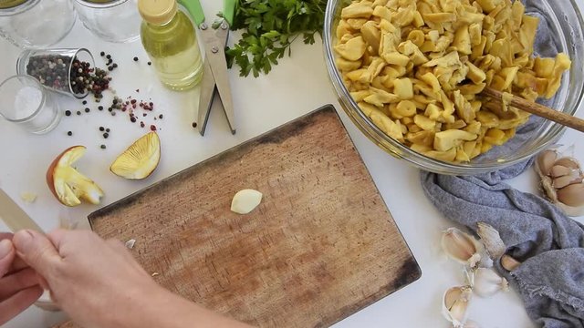 Personal perspective of woman hands cooking Amanita caesarea (known as Caesar's mushroom)
