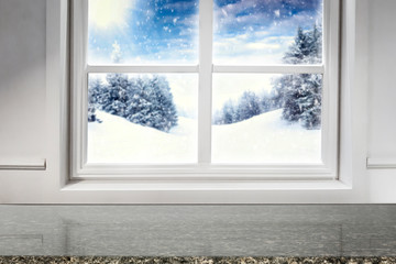 Obraz premium Winter decorations in bright colors with blurred snowy white and silver winter outside the window background.