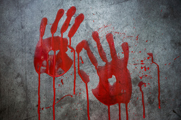 Two bloody handprints, with bruising on a black background. Horror, mysticism, background for...