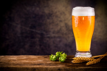 Glass of natural beer. On wooden table
