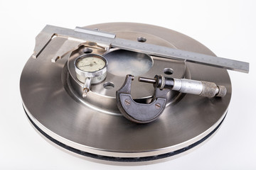 Brake discs and measuring instruments. Car parts workshop measurements.
