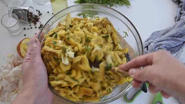 Personal perspective of woman hands cooking Amanita caesarea (known as Caesar's mushroom)