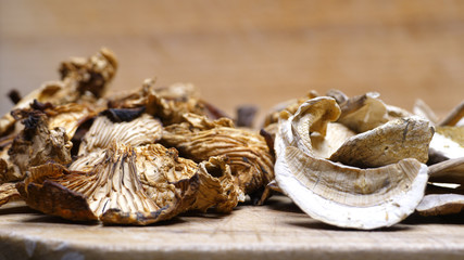 A closeup collection of dried mushrooms on a cutting board