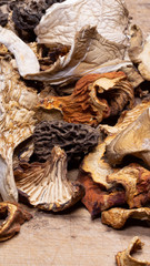 A closeup collection of dried mushrooms on a cutting board