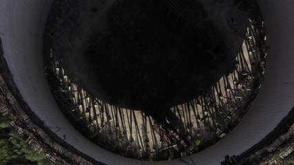 The unfinished cooling tower of the 5th and 6th power units of an abandoned city was shot by the drone from top to bottom with counterclockwise rotation
