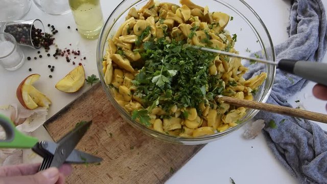 Personal perspective of woman hands cooking Amanita caesarea (known as Caesar's mushroom)