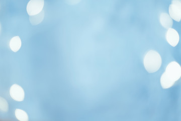 Blur white circle lights. Festive gleam design. Defocused sky blue abstract background. Copy space.