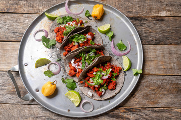 Mexican chorizo tacos with blue corn tortillas on rustic background