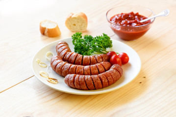 sausage and vegetables served on a wooden board for copy space