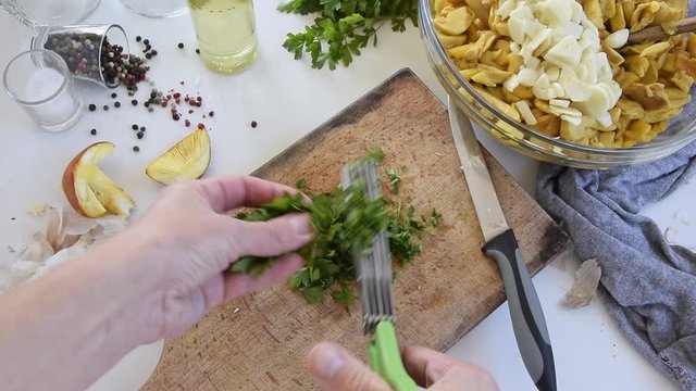 Personal perspective of woman hands cooking Amanita caesarea (known as Caesar's mushroom)