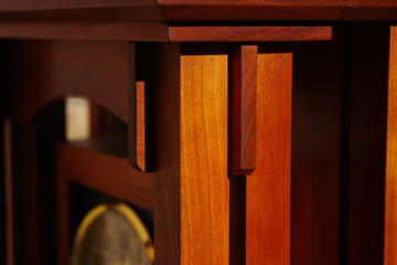 FinisheShadows and highlighted finished cherry wood of a mantel clock