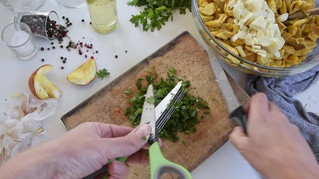 Personal perspective of woman hands cooking Amanita caesarea (known as Caesar's mushroom)